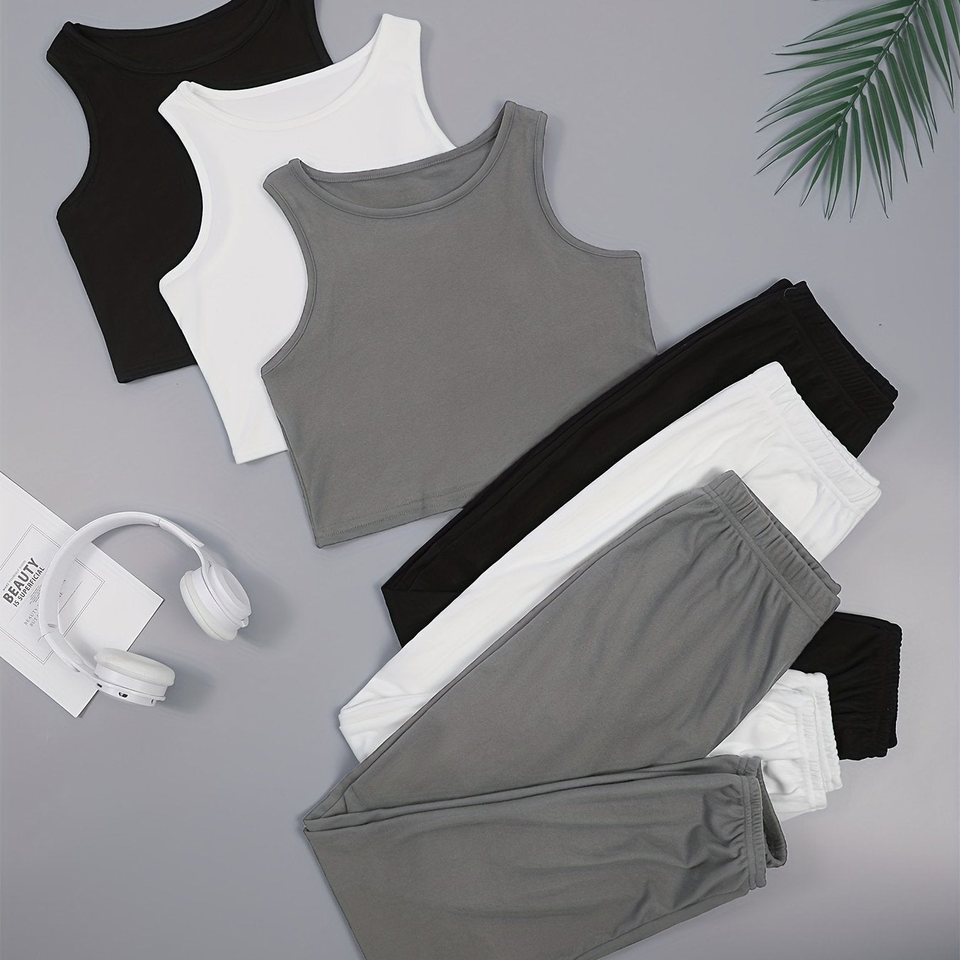 Three sets of women's solid color vest and shorts pajama sets.