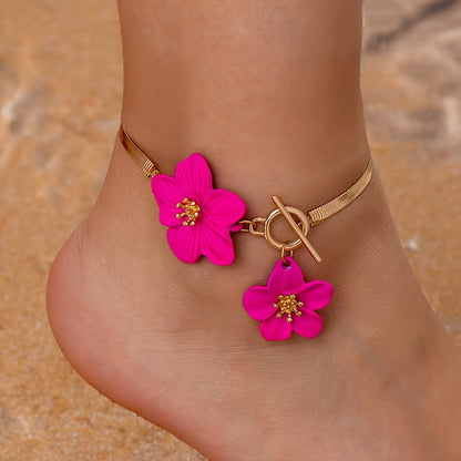 Stylish gold-tone anklet with white flower charms, perfect for vacations and everyday wear.