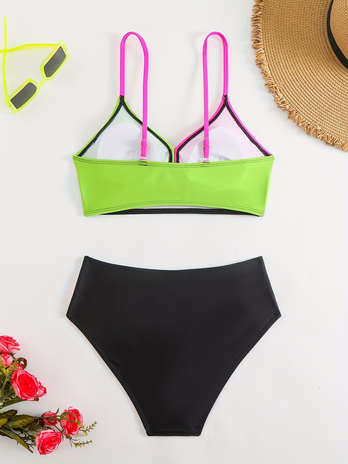 Patchwork two-piece swimsuit with crossed colors and high-waisted design.