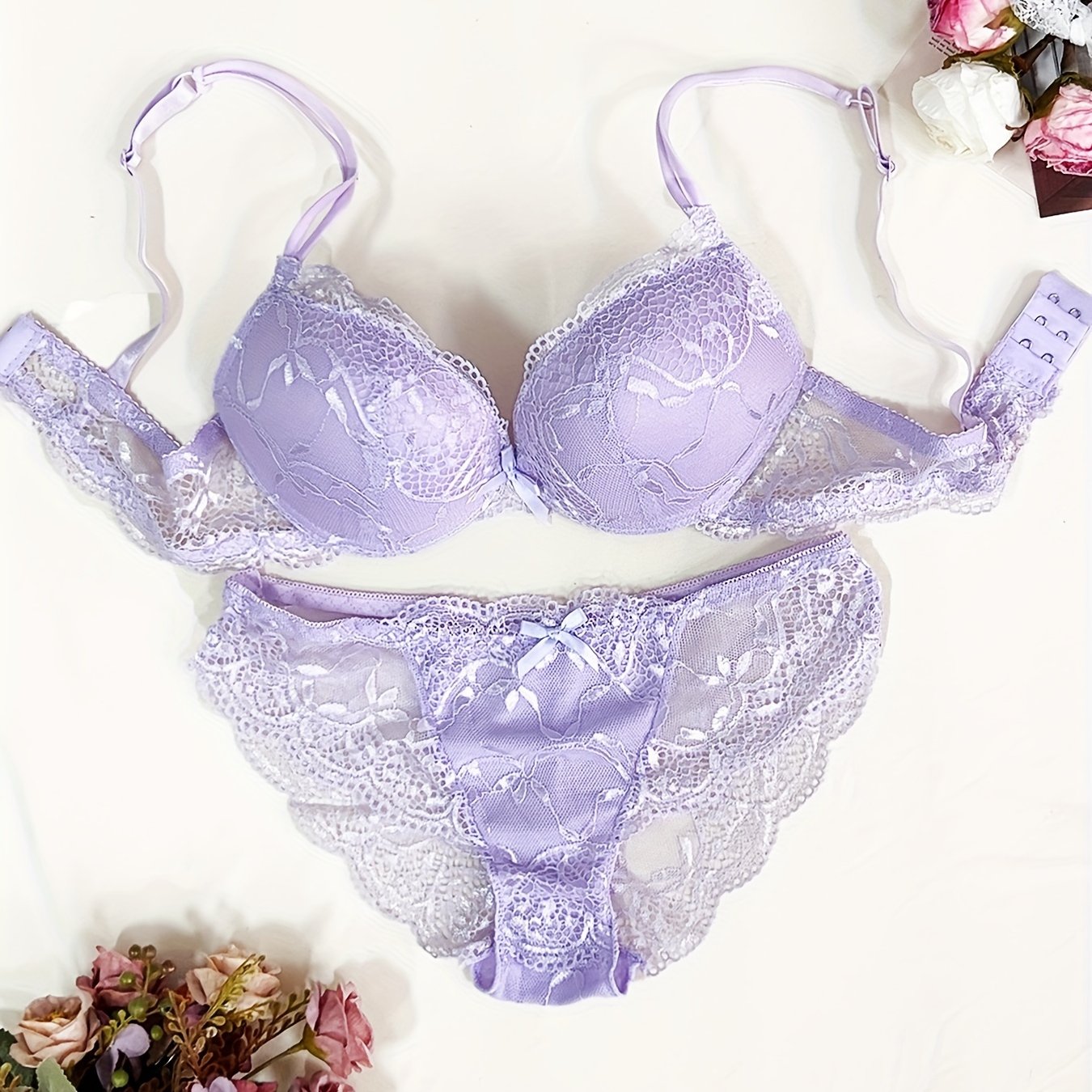 Medium support lace bra and panty set with contrast lace detail, made of 85% polyamide, 7% polyester, 5% elastane, and 3% viscose. Features drop waist briefs and chest pad.