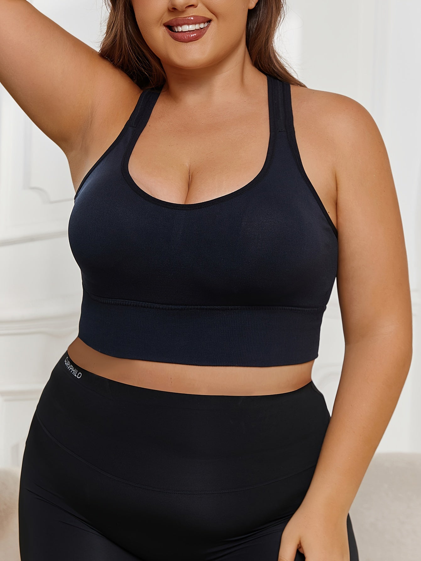 Plus Size Seamless Sports Bra made of solid color knit fabric with medium stretch, composed of 83% polyamide and 17% elastane. Features removable padding, wireless design, and a lightweight