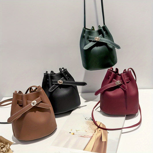 Vintage-style mini bucket bag made of solid color synthetic leather with buckle closure, unlined. Ideal for daily commute and shopping. Available in black, burgundy, light brown, and dark