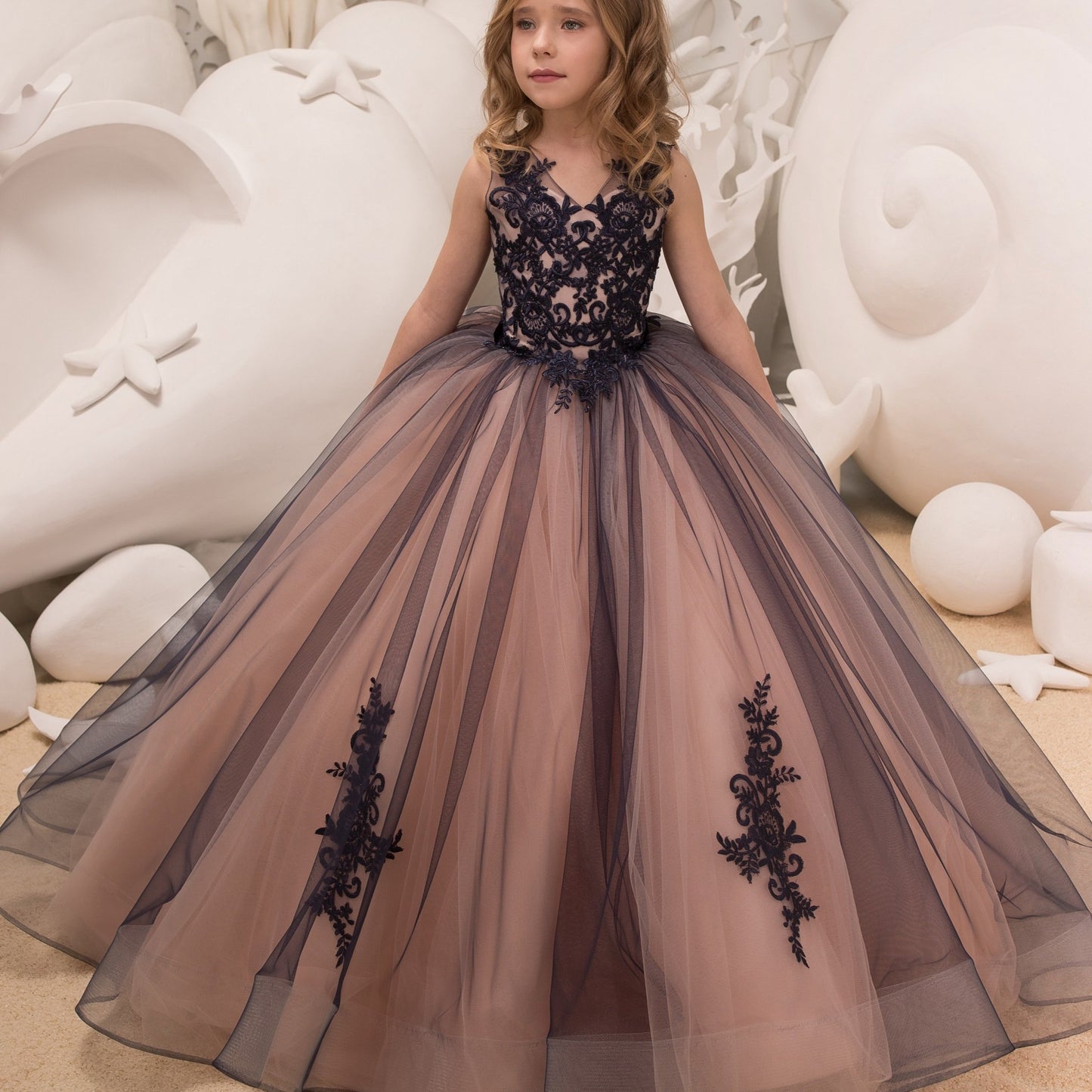 Sleeveless girls' gown with floral appliqué, perfect for performances and piano recitals.