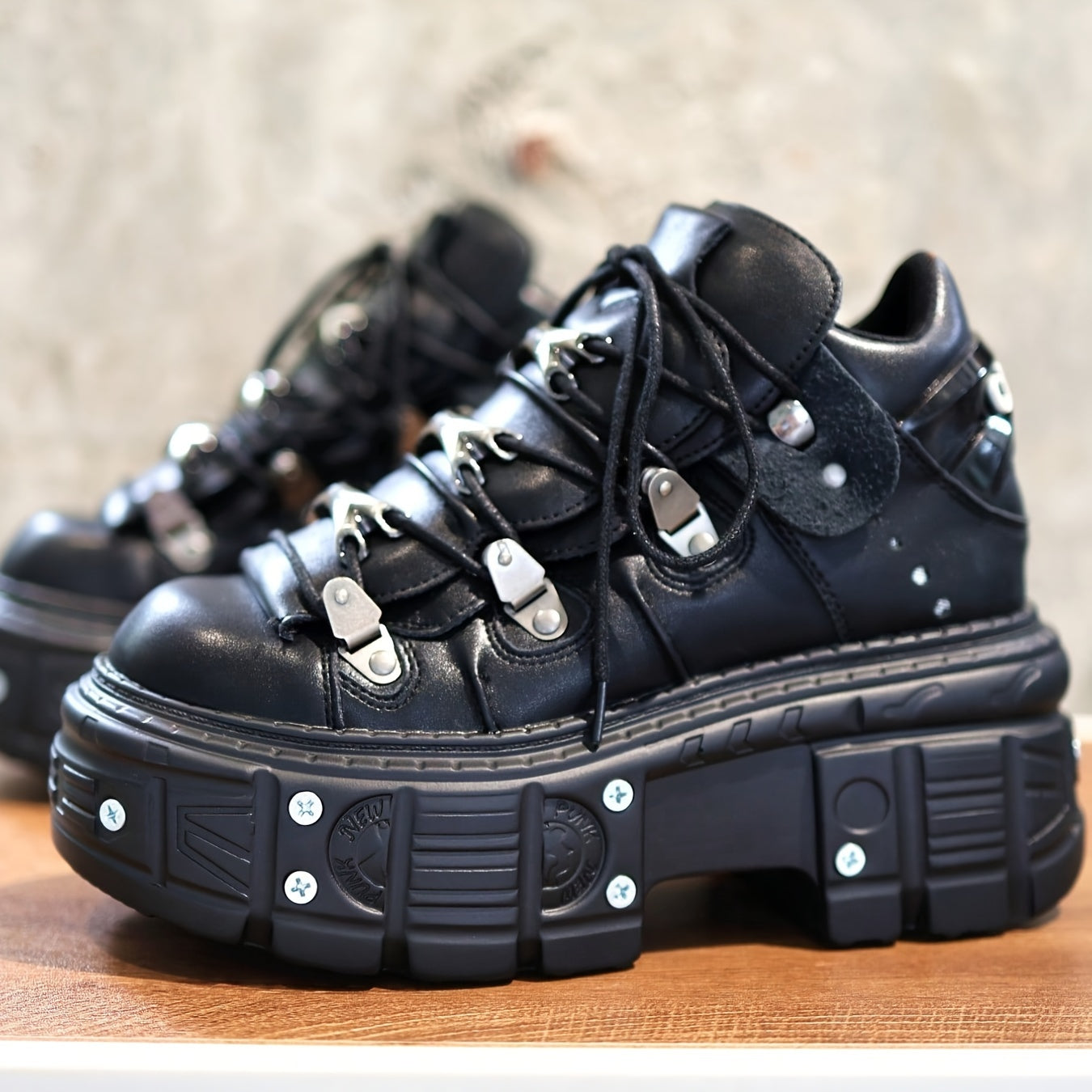 Black women's mid-top sneakers with metallic accents, waterproof, thick platform sole, lace-up Y2K goth style.