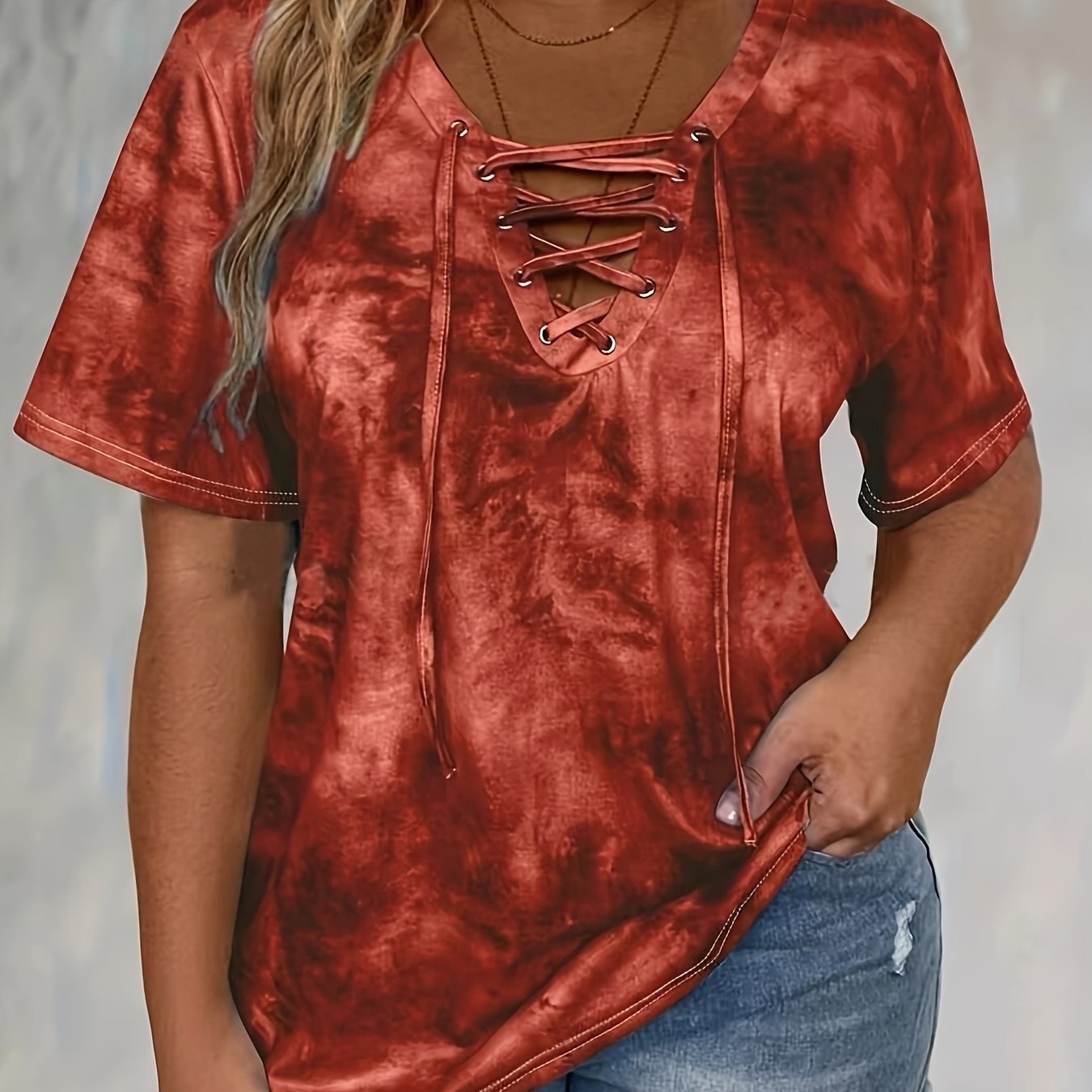 Plus size tie dye print t-shirt for women, made of polyester knit fabric with spandex. Features a lace-up drape neck detail and medium stretch. Ideal for spring/summer casual wear.