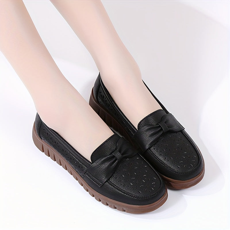 Flat loafers for women with hollow out design, bow detail, soft sole, suitable for casual walking.