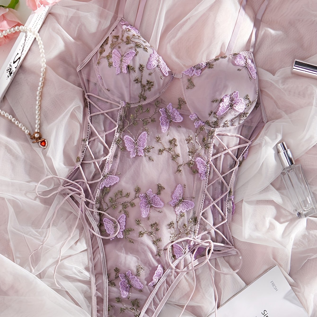 Purple butterfly embroidered teddy bodysuit with deep V-back, thong bottom, sheer mesh, hand washable, for women.