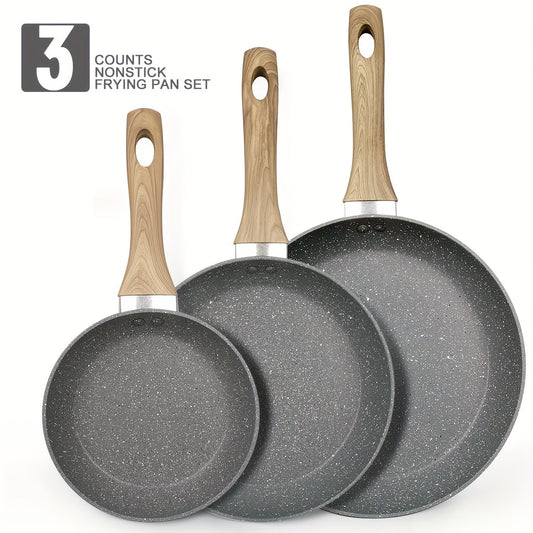 Set of three aluminum cookware pieces with non-stick coating that is free of PFOA and PFAS, suitable for induction cooking. Includes three egg frying pans in varying sizes (17.78cm, 24.13cm, 27.94cm) for easy food release. Ideal for creating healthy