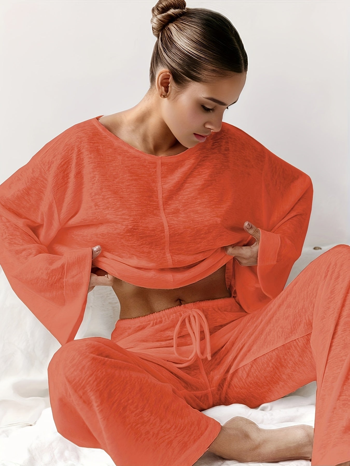 Women's two-piece set of loose and comfortable home clothes made with micro-permeable fabric, featuring round neck and long sleeves.