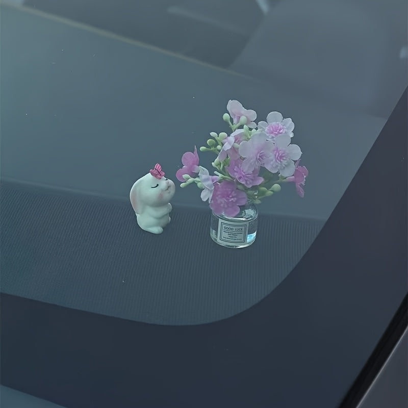 Miniature resin vase for car dashboard décor with healing figurine.