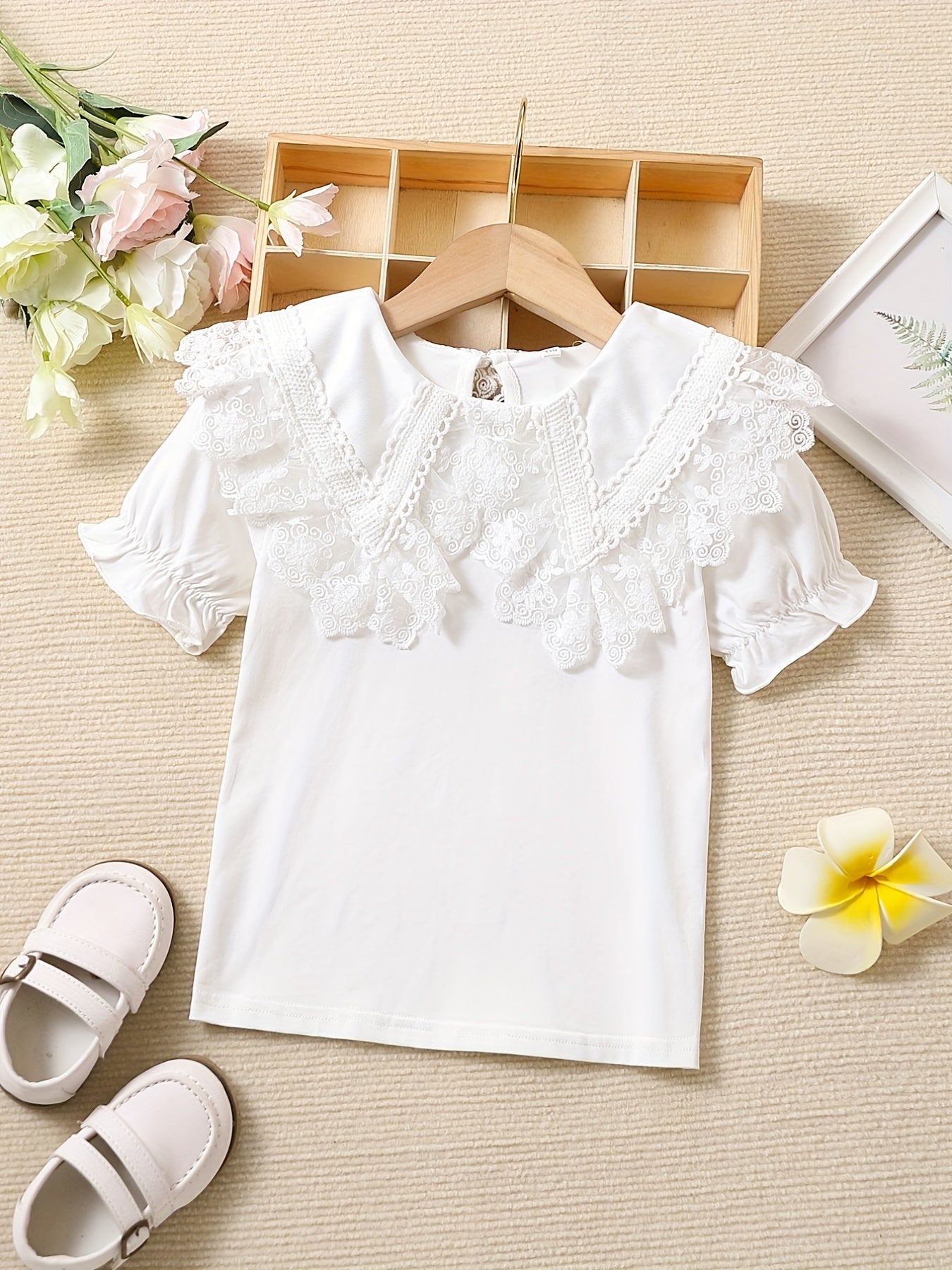 Girls' cotton knit T-shirt with lace collar detail, ideal for summer. Stretchy, breathable, and machine washable.