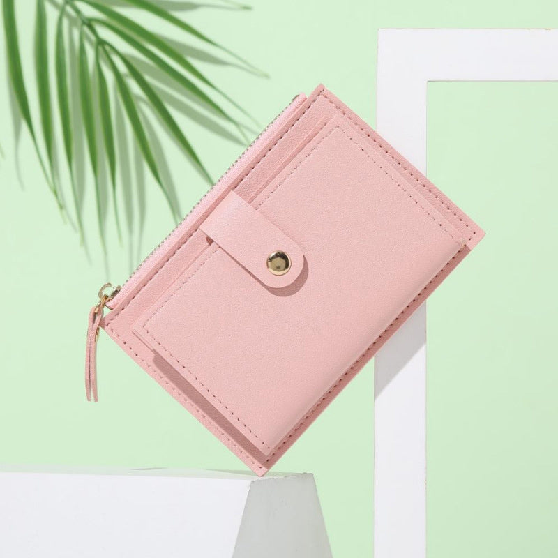 Slim short wallet for women with zipper closure, bifold design, credit card slots, coin purse, and solid color.