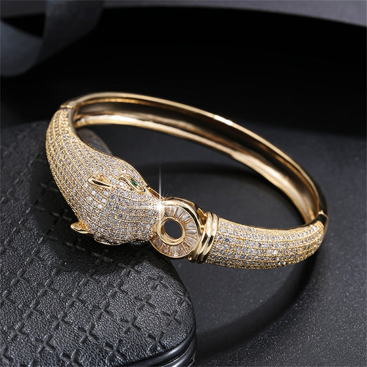 An elegant bracelet featuring a striking leopard head design, adorned with synthetic zirconia stones, making it a distinctive and opulent accessory for women to elevate their look at weddings and formal events.