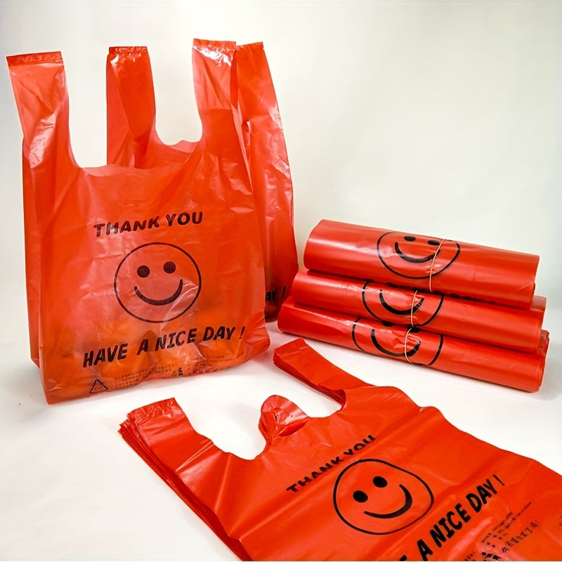 Pack of 50 Red 'Thank You' Plastic T-Shirt Bags with Joyful Face Design - Strong and Reusable, Ideal for Shopping and Packaging. Uncoated Finish, Perfect for Supermarket and Personal Use. Foldable and Easy to Carry.