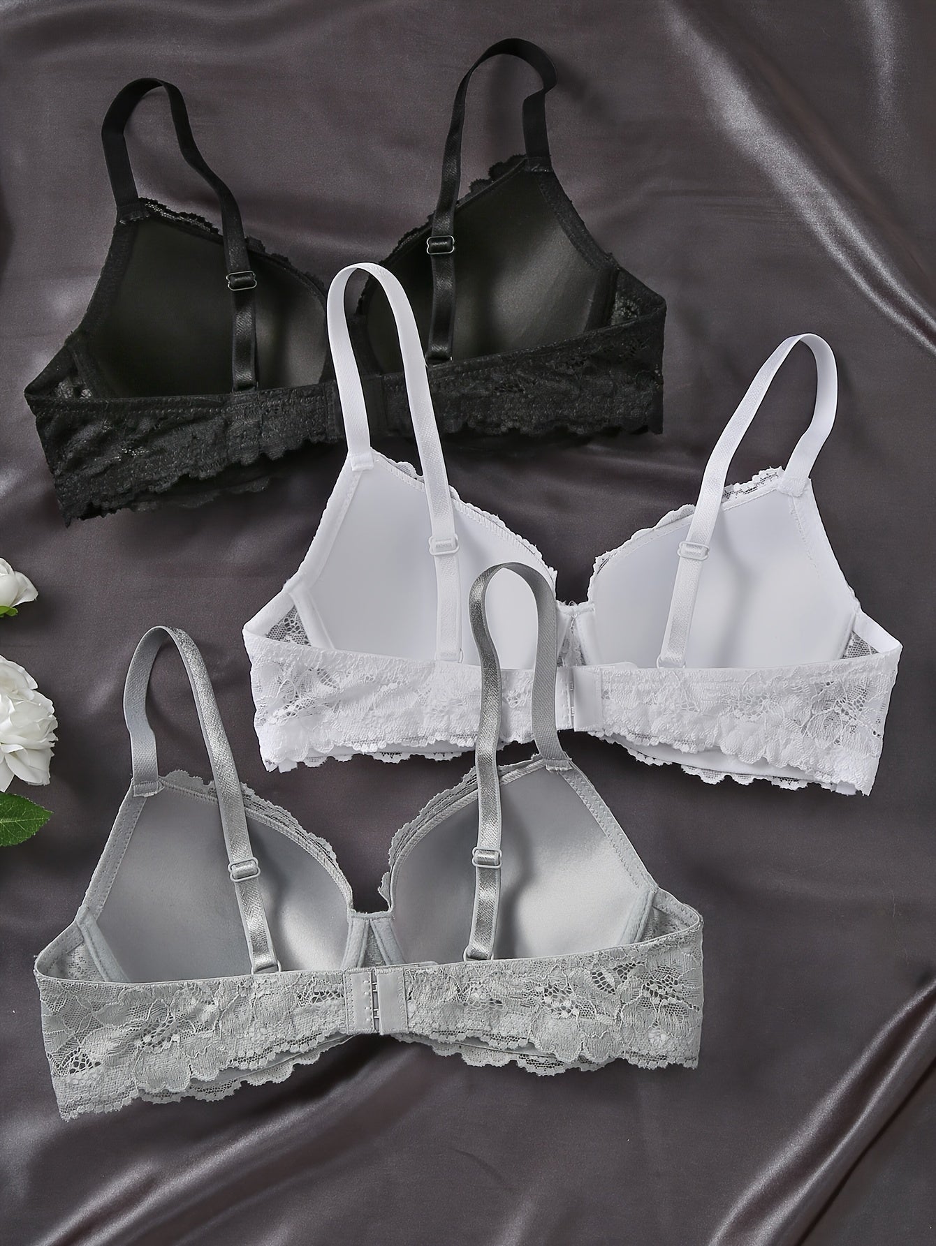 Three elegant lace push-up bras with underwire for women in black, white, and gray. Non-removable pads, hand washable, and comfortable polyamide blend.