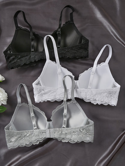 Three elegant lace push-up bras with underwire for women in black, white, and gray. Non-removable pads, hand washable, and comfortable polyamide blend.