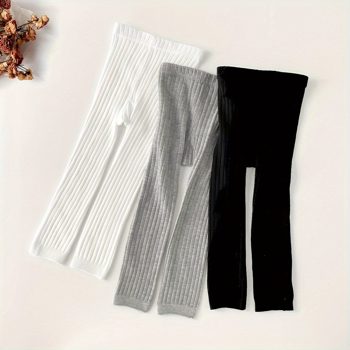 Baby leggings, girls' tights, and toddler stretchy pants in a 3-pack. Made of a polyester blend, hand wash only. Knit fabric in solid colors suitable for all-year wear. Comfortable for