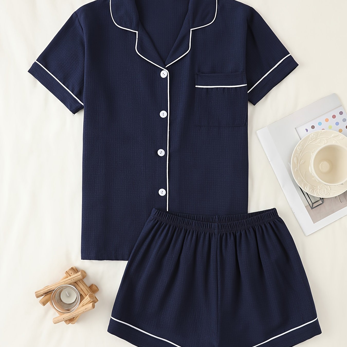 Basic pajama set for women, featuring a short-sleeve button-up top with lapel collar and elastic shorts.