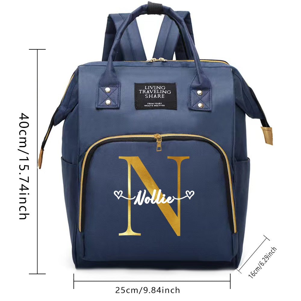 Customize your Oxford cloth diaper bag with your own initial, featuring a large capacity and soft shell. This mommy backpack is perfect for casual travel and comes with a convenient bottle nursing storage organizer for women.