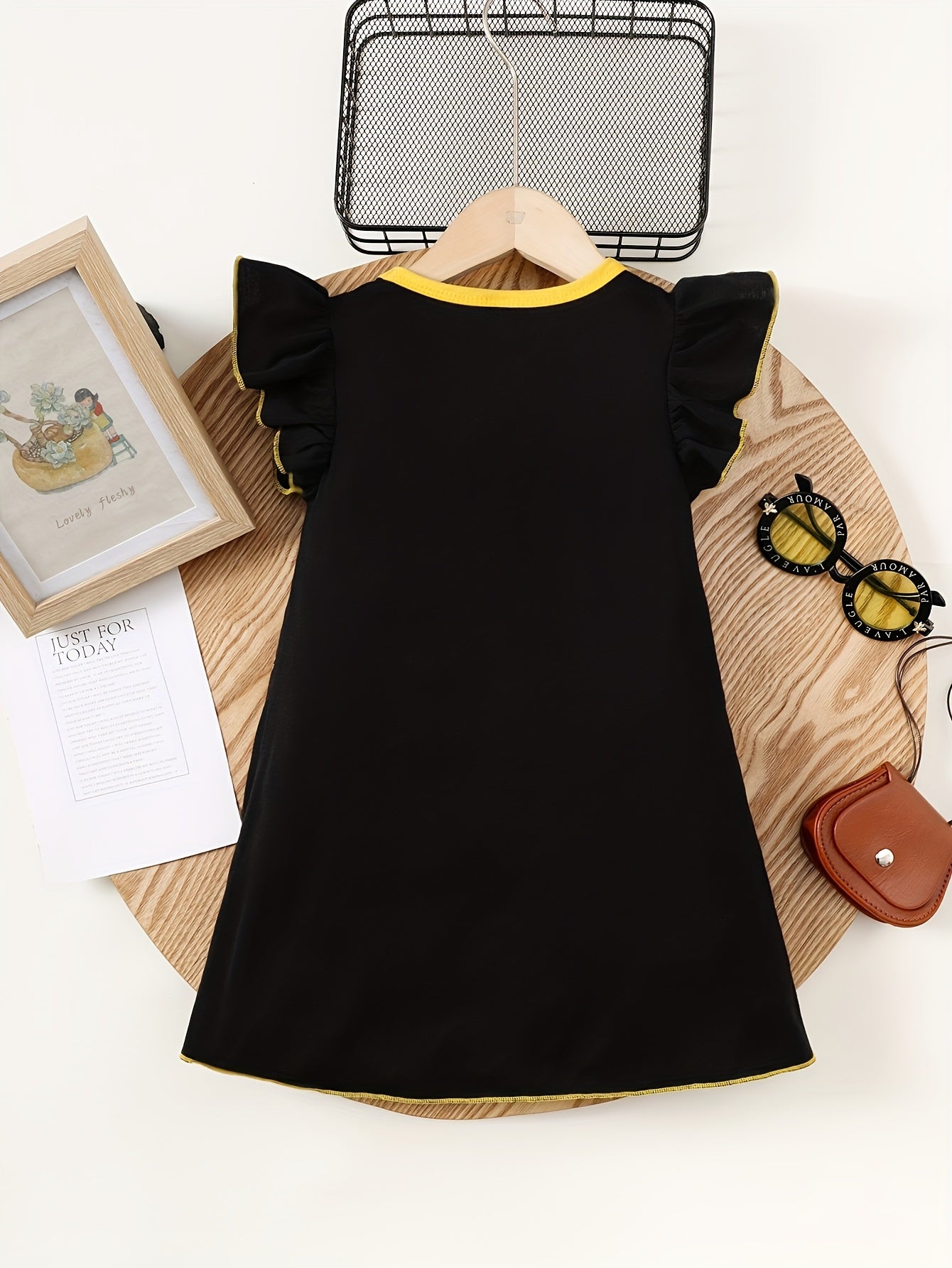 Cute sleeveless summer dress for girls featuring a cartoon girl with lanterns and moon print. Made of soft polyester with ruffled detail, in a yellow and white design suitable for casual