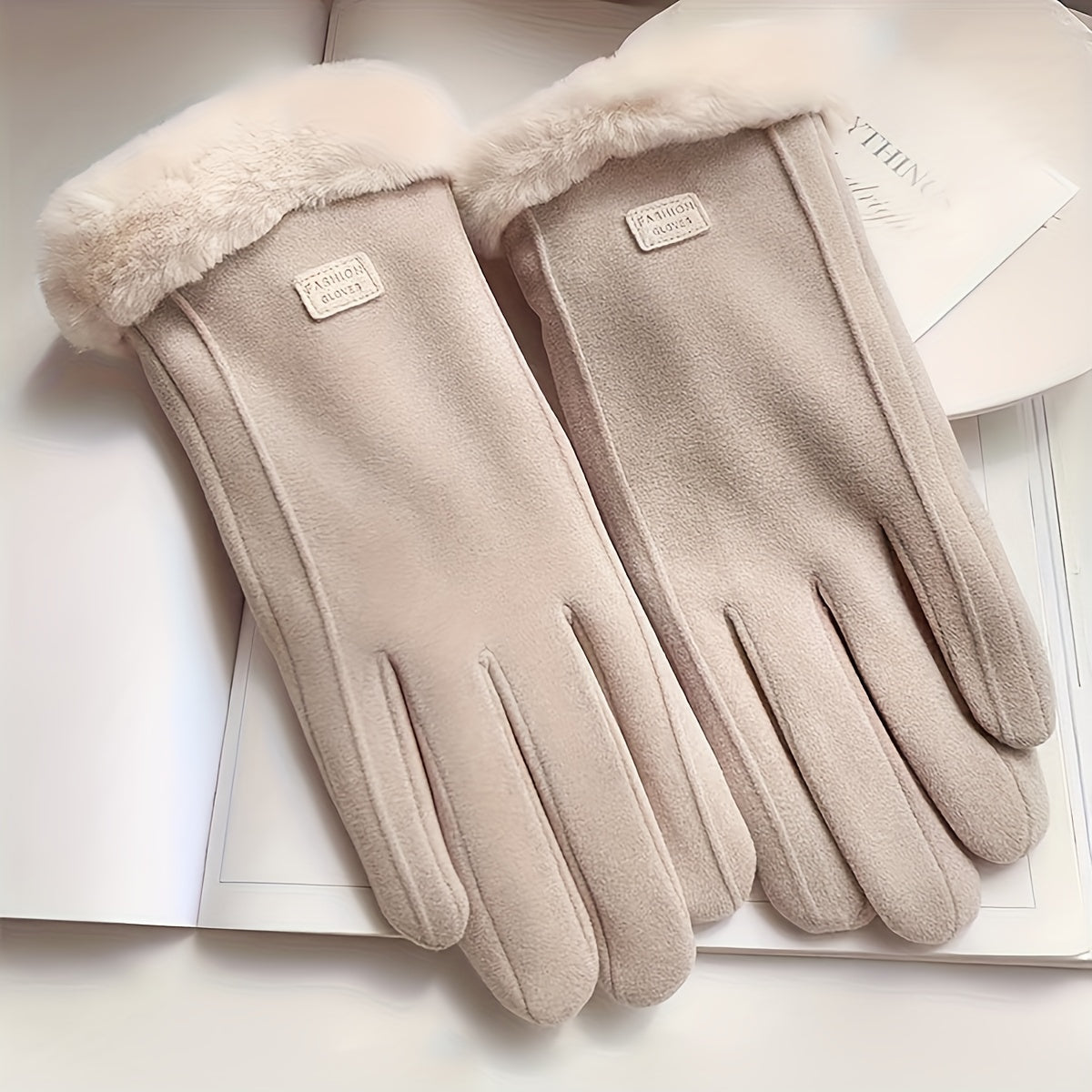 Warm and comfy beige touchscreen gloves for women with a plush lining to keep hands cozy in the winter featuring a full finger design.