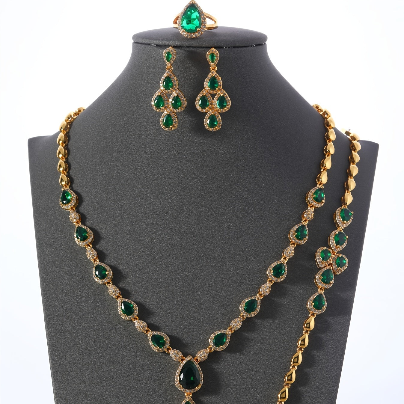 A set of four pieces of stunning Middle Eastern women's wedding jewelry from Saudi Arabia, featuring full inlay peacock green water drop-shaped cubic zirconia on copper. The set includes one necklace, one bracelet, one ring, and one pair of earrings.