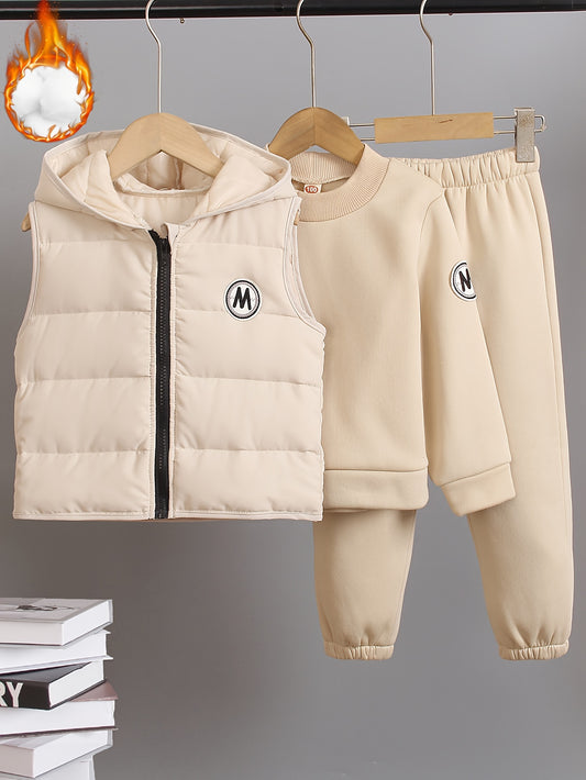 Toddler autumn/winter casual set includes beige zip-up hoodie vest, long sleeve sweatpants with "M" logo. Made of polyester blend knit fabric. Stylish outfit for outdoor wear.