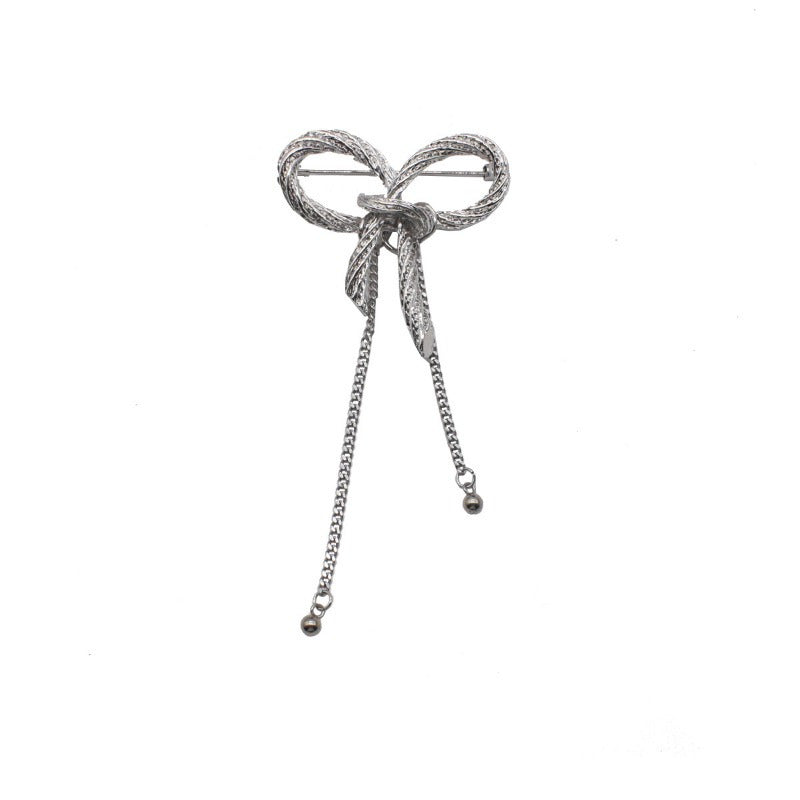 Add a touch of elegance with the SKEDS Bowknot Brooch Pin, featuring a unique design with enamel bow ribbon and tassel chains. This fashionable accessory is perfect for both men and women.