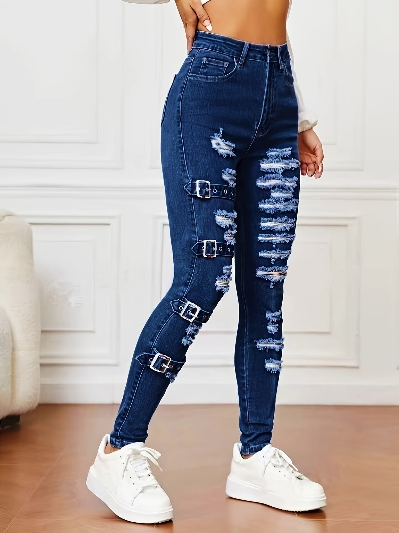 High-waisted stretchy jeans with rip and repair details for women, cotton/polyester blend, machine washable, suitable for all seasons.