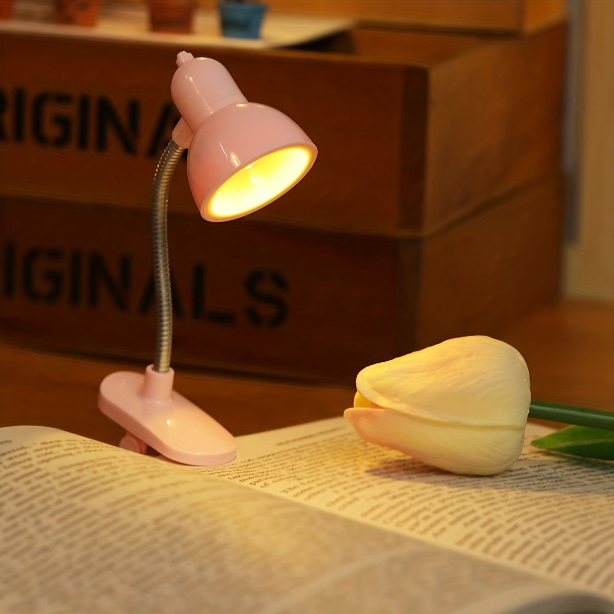 Mini clip-on reading lamp with push button control, adjustable arm, and fantasy-themed brushed finish made of plastic material. Battery operated for bedroom tabletop use as a night light.