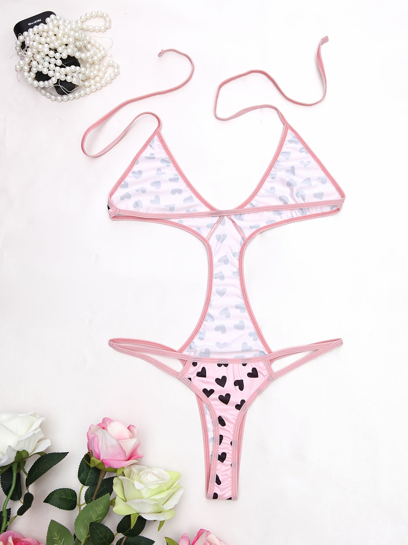 Women's sexy heart pattern bodysuit made of 90% polyamide and 10% elastane knit fabric, ideal for adults.