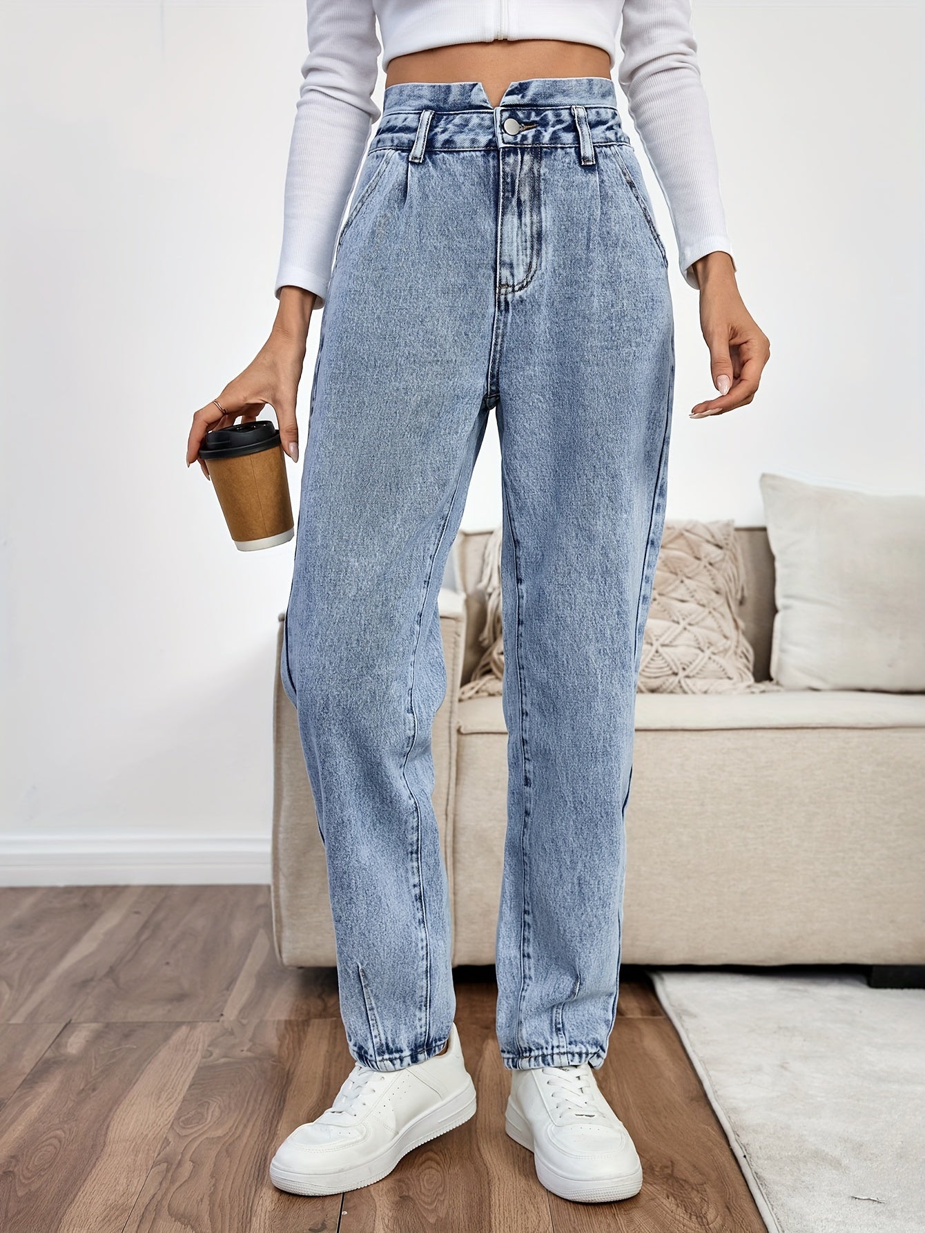 Women's light blue high-waisted straight-leg denim jeans with slash pockets, button closure, and non-stretch cotton material for casual spring/fall wear.