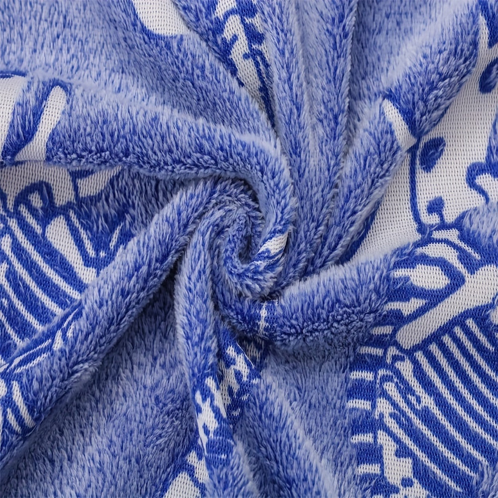 The perfect gift for dinosaur enthusiasts - a cozy blue luminous polyester throw blanket that glows in the dark.