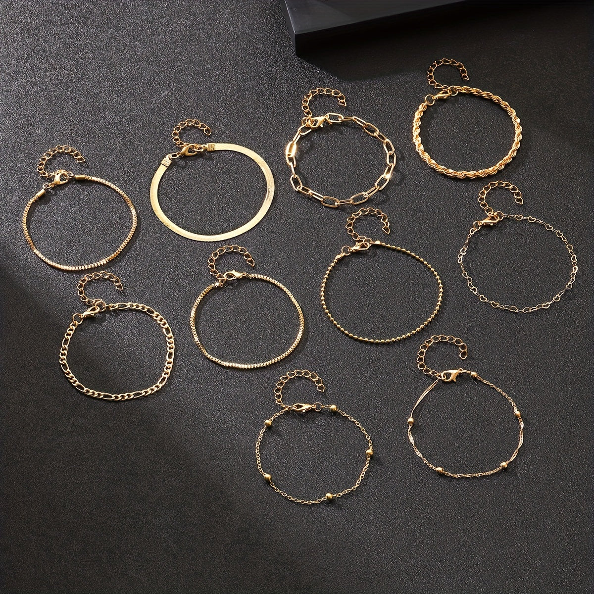 Set of 10 elegant golden bracelets for women, stylish and versatile for daily wear or vacation, great gift idea.