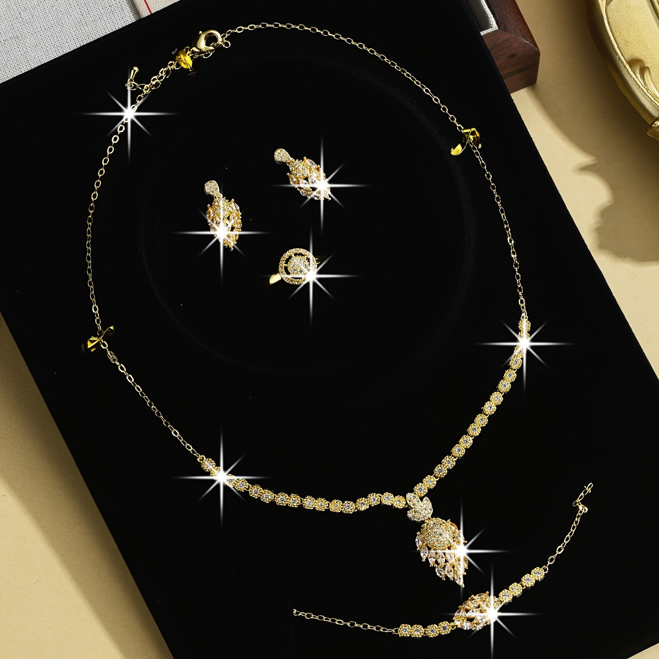 Luxurious Floral Design Women's Bridal Jewelry Set, Featuring 5 Pieces in 18K Gold-Plated Copper with Synthetic Cubic Zirconia Stones. Set includes Necklace, Earrings, and Bracelet. Perfect for Both Daily Wear and Special Wedding Occasions.