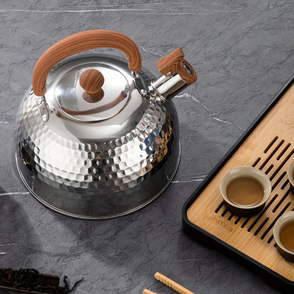 An outdoor-friendly stainless steel kettle with a hammered texture and a whistling spout, ideal for boiling water in the backyard to make tea or coffee.