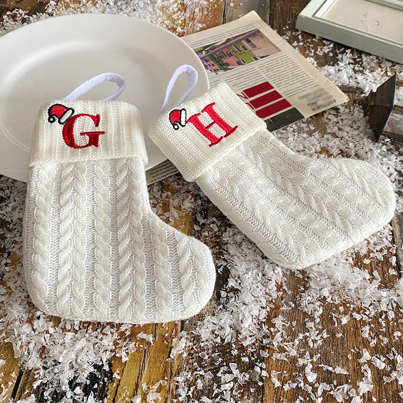 White cable knit stocking with embroidered 'F' - Ideal for indoor decor.