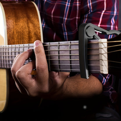 Guitar capo with 5 picks and quick change clamp for acoustic and electric guitars. Includes bonus guitar picks.