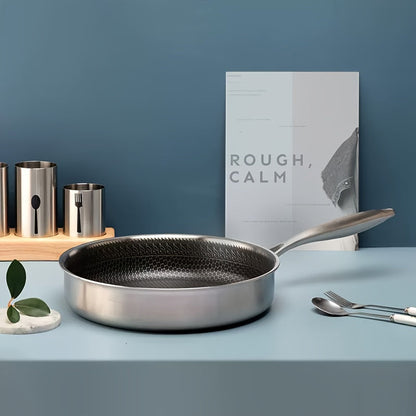 A durable kitchen essential, this 11-inch tri-ply stainless steel frying pan features non-stick coating and high sides for easy flipping and serving. It is oven and dishwasher safe, and compatible with induction, electric, and gas stoves.