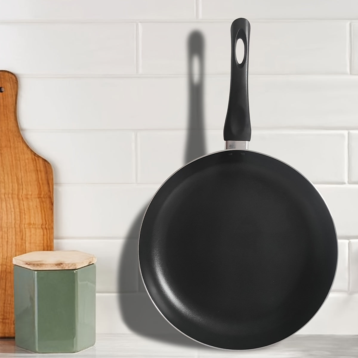 Get the perfect 10.8-inch black aluminum non-stick frying pan for your low-fat cooking needs! This pan is ideal for cooking eggs and steak with its easy grip handle, lightweight design, and scratch-resistant coating. It is compatible with gas, electric