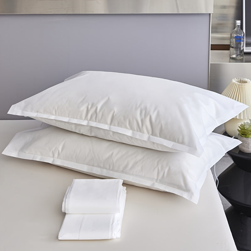 Two pieces of sterile disposable travel pillow covers with sealed envelopes. They are partially cleaned, pure white, and made of thick breathable non-woven polyester. Ideal for travel, hotels, and salons. The covers are unprinted and come in a pair. Use