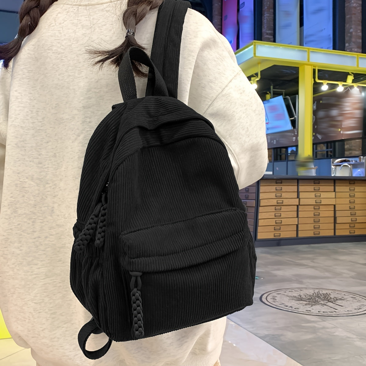 Small corduroy fashion backpack for women in black, with adjustable straps and zipper closure