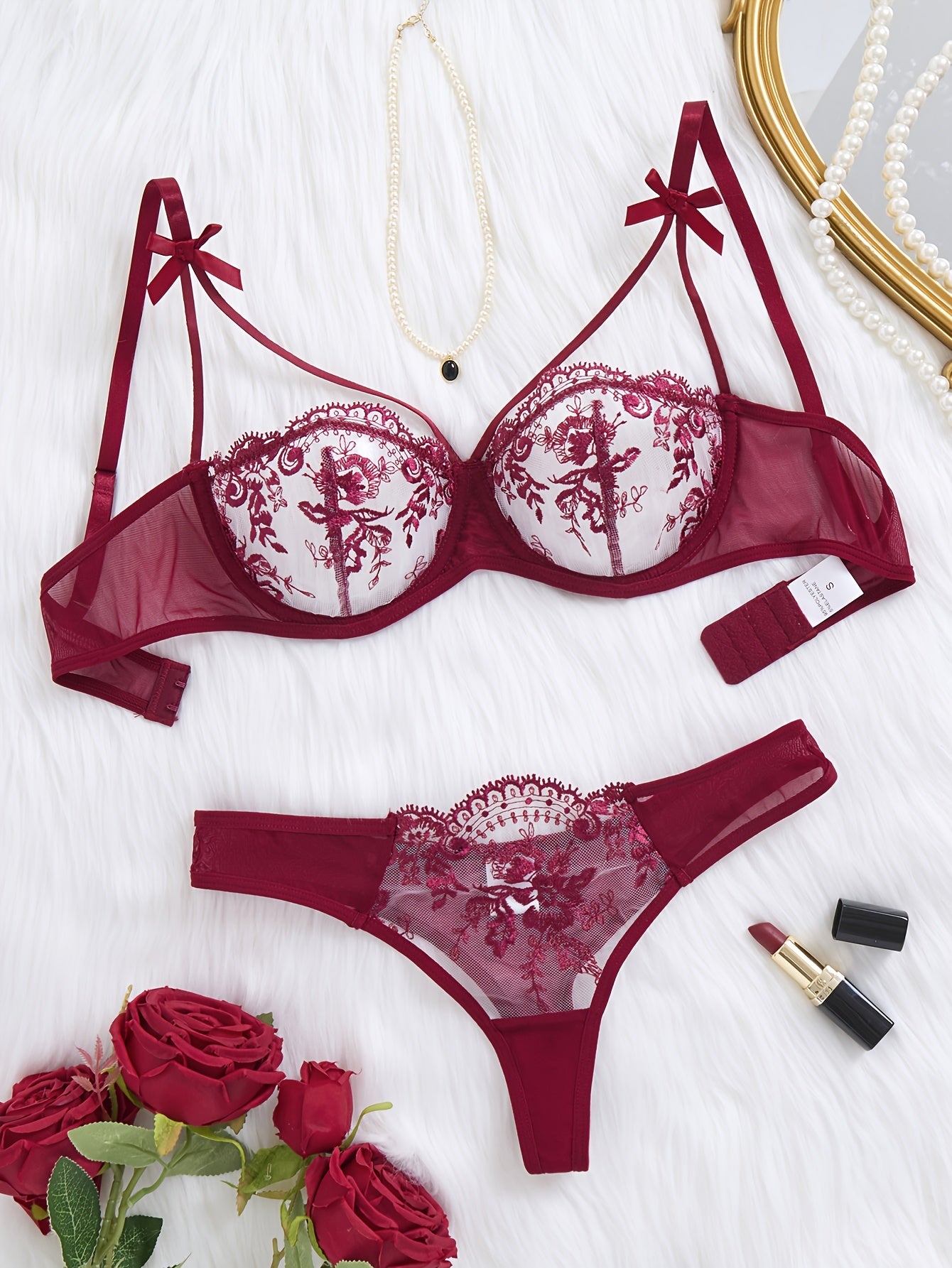 Floral embroidered two-piece bra set with semi-transparent fabric.