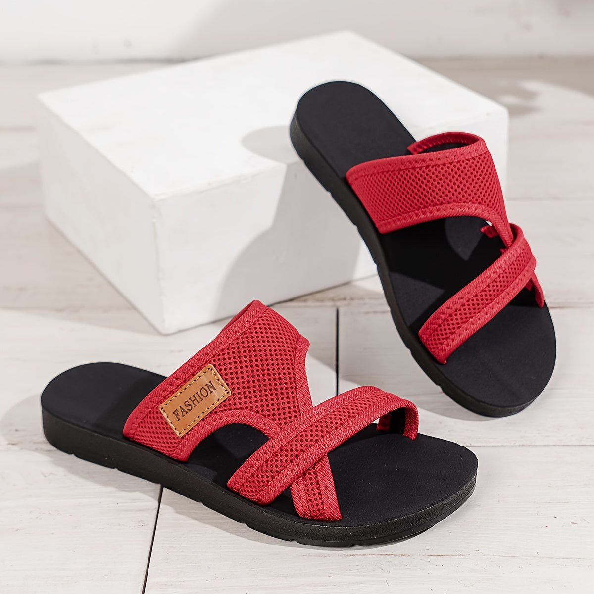 Breathable mesh slide sandals for women with crisscross straps, lightweight and comfortable. Available in Black/Brown or Red/Black. Suitable for casual indoor and outdoor wear.