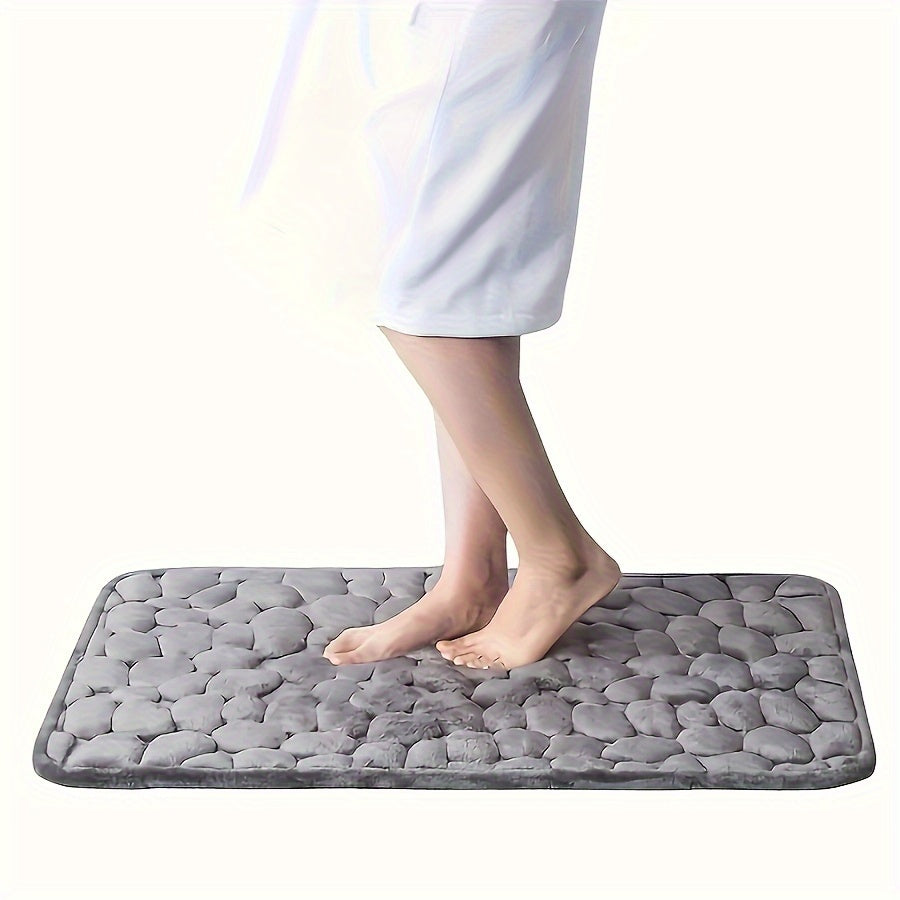 One piece of bath mat with embossed pebble pattern, highly absorbent and non-slip for bathroom use. Suitable for tub, toilet, and floor, made of machine washable polyester material. Dimensions are 59.94x39.88 cm.