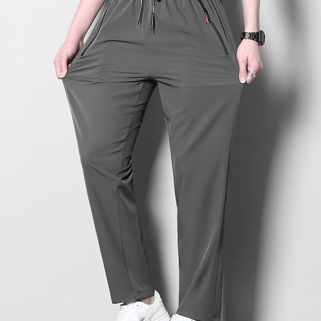 Men's plus size casual sports pants, made of stretchy polyester in a solid color with a regular fit, zipper detail, part of the spring/summer collection.