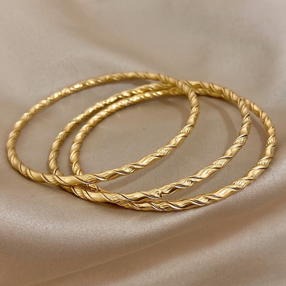 Set of 3 Golden Twist Stainless Steel Bangles, featuring a Chic Classic Tibetan Buddha design. Can be stacked for a stylish look, perfect for both women and men.