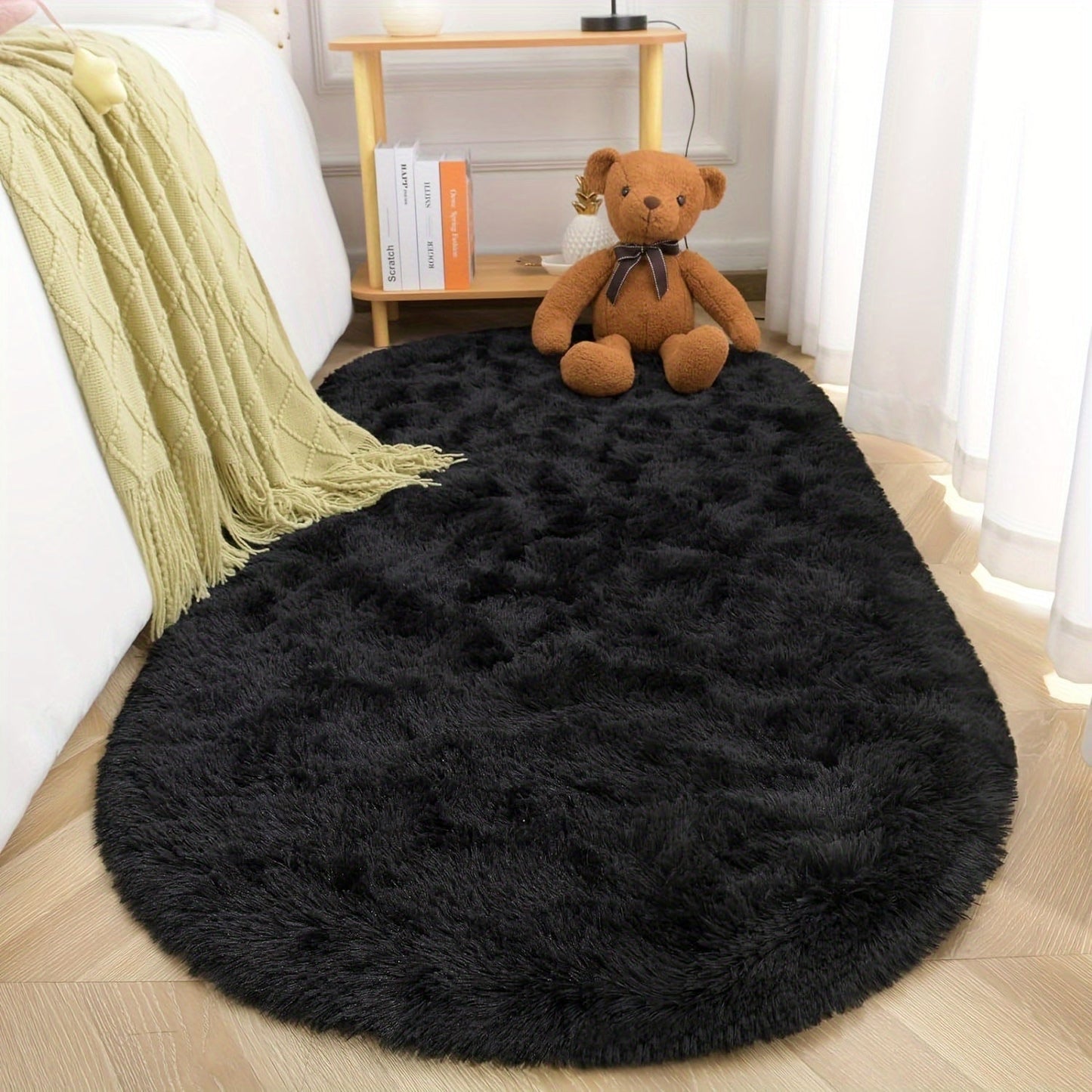 Soft and fluffy oval shaggy area rug, perfect for bedroom or living room. Made with skin-friendly thickened sponge and tufted polyester material. Durable and easy to maintain. Adds decorative touch to indoor spaces such as sofa, bedside, playroom, or