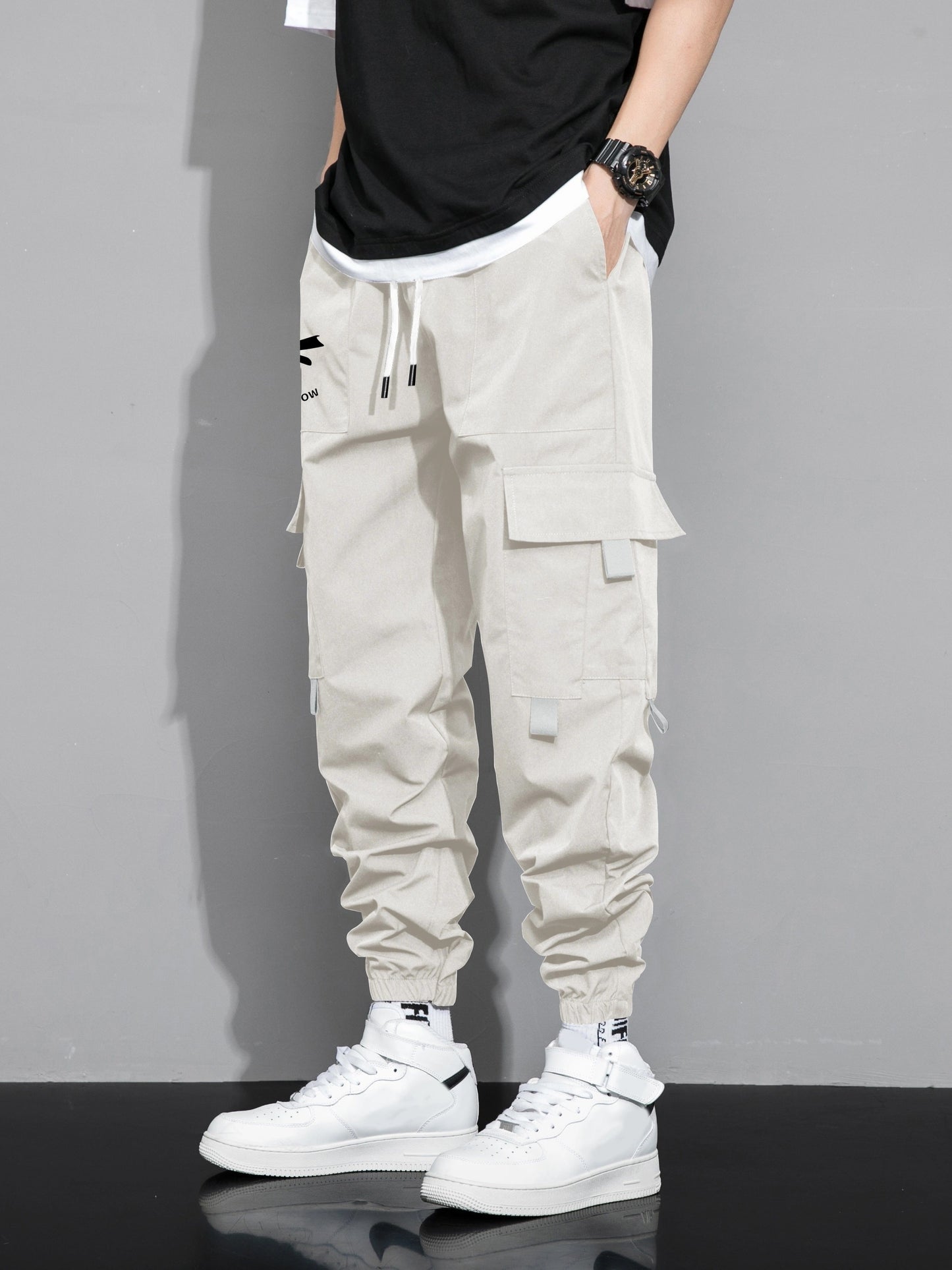 Stylish cargo pants with multiple pockets for men, featuring a loose fit and drawstring waistband for a casual outdoor streetwear look.