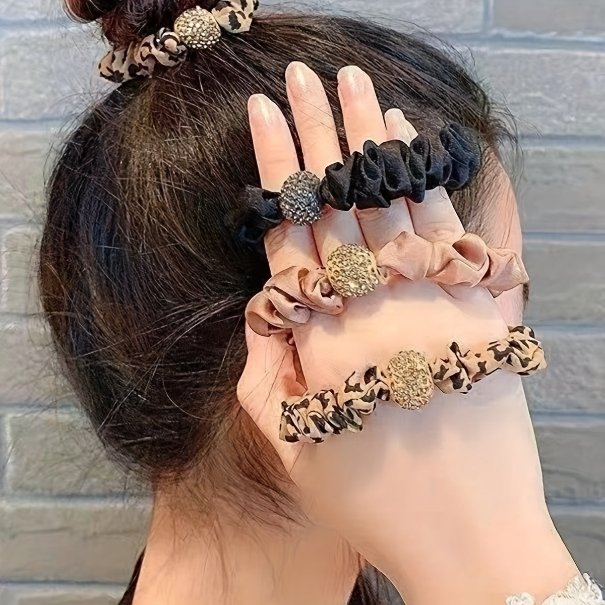 Set of 4 high elastic rhinestone hair ties with plain and leopard print designs.